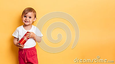 Vichuga. Russia. February 27, 2020: A happy girl stands with a can of Coca-Cola in her hands. The products contain a lot Editorial Stock Photo