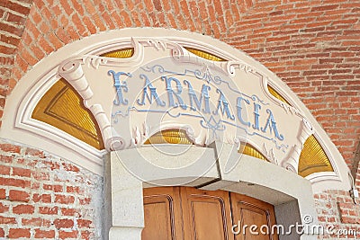 Arcade in red bricks around Sanctuary of Vicoforte church, ancient pharmacy sign in Italy Editorial Stock Photo