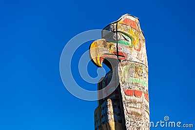 Totem pole located in front of the Royal BC Museum over blue sky Editorial Stock Photo