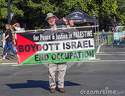 VICTORIA, CANADA- AUGUST 4, 2019: Man stands in downtown victoria protesting-holding a sign for Peace and Justice for Palestine Editorial Stock Photo