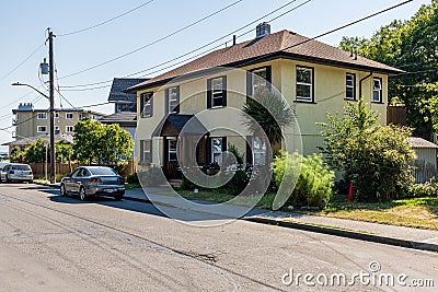 VICTORIA, CANADA - JUNE 29, 2021: Yellow house on Memorial Crescent city street in old part city of Victoria Editorial Stock Photo