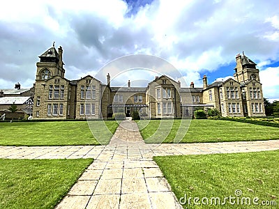 Victorian stone built psychiatric hospital, with grass lawns in, Menston, Leeds, UK Stock Photo