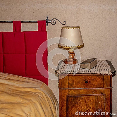 Victorian style decorated bed and side table with bible Stock Photo