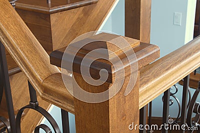 Victorian style staircase wood newel post haindrail brown metal baluster close-up Stock Photo