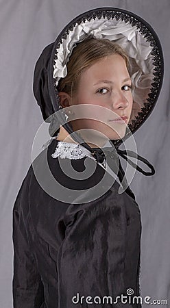 Victorian woman in a black bodice and bonnet Stock Photo