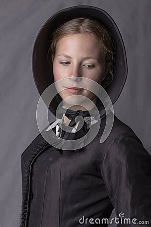 Victorian woman in a black bodice and bonnet Stock Photo
