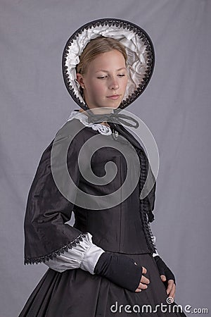 Victorian woman in a black bodice and bonnet Stock Photo