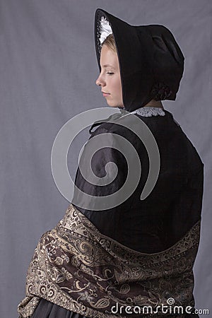 Victorian woman in a black bodice, shawl and bonnet Stock Photo