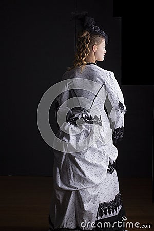 Victorian woman in black and white bustle dress and hat Stock Photo