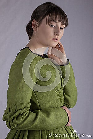 Victorian woman in a green bodice and skirt Stock Photo
