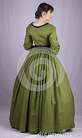 Victorian woman in a green bodice and skirt Stock Photo