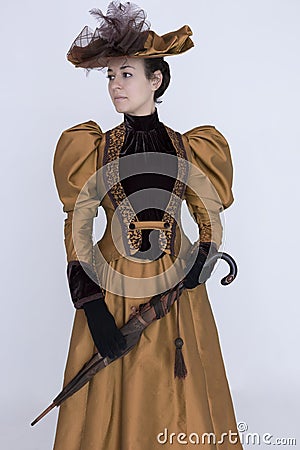 A Victorian woman wearing a bronze and brown silk ensemble Stock Photo