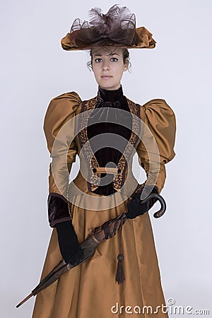 A Victorian woman wearing a bronze and brown silk ensemble Stock Photo