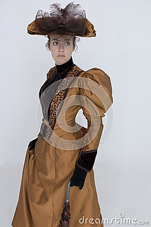 A Victorian woman wearing a bronze and brown silk ensemble Stock Photo