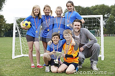 Victorious School Soccer Team With Medals And Trophy Stock Photo