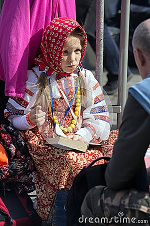 Victory Day in Moscow. Beautiful girl in national uniform with a book on Victory Day. Editorial Stock Photo