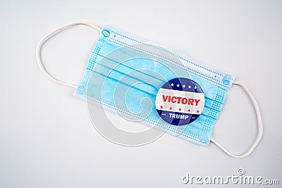 victory trump text on american election vote button on face mask. Stock Photo