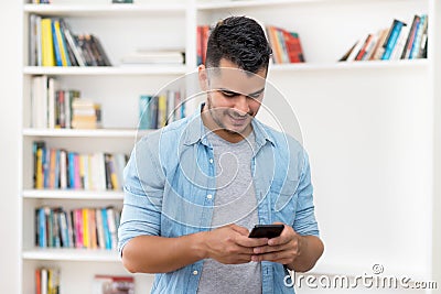 Video call of mexican hipster man in quarantine with mobile phone Stock Photo