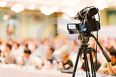 Video camera set record audience in conference hall seminar event. Company meeting, exhibition convention center concept Stock Photo