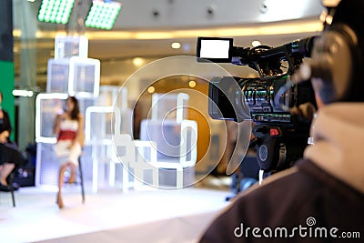 video production camera recording live event on stage. television social media broadcasting seminar conference. Stock Photo