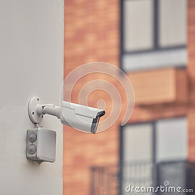 Video surveillance camera on the building, monitoring the security of a window residential house Stock Photo