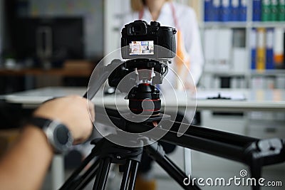 Videographer filming online broadcast about medicine in clinic with doctor Stock Photo