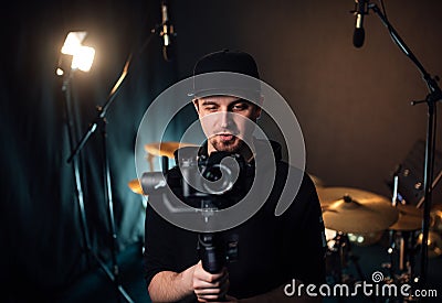 Videographer filming at a recording studio. Stock Photo