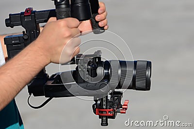 Videographer shoots video with mirrorless camera with stabilizer Stock Photo