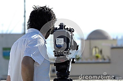Videographer with tripod camera in documentary film shooting Editorial Stock Photo