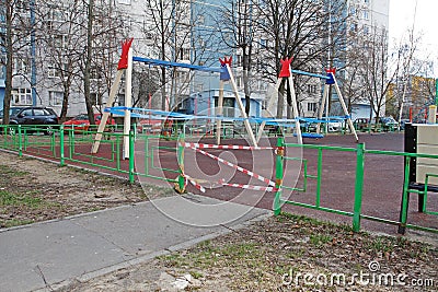 Children`s playground fenced with red-white tape during the quarantine COVID-201 Editorial Stock Photo