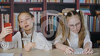 Vidéo de selfie de tir de la fille de blogueuse au téléphone portable dans la salle de classe de l'école. Diffusion en direct de t banque de vidéos Vidéo de selfie de tir de la fille de blogueuse au téléphone portable dans la salle de classe de l'école. Diffusion en direct de t banque de vidéos