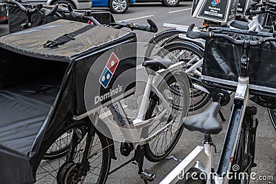 View of Domino Pizza, an American multinational pizza restaurant chain , delivery scooter Editorial Stock Photo
