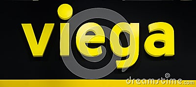 Viega company logo. Plastic yellow letters with lights on the black wall Editorial Stock Photo