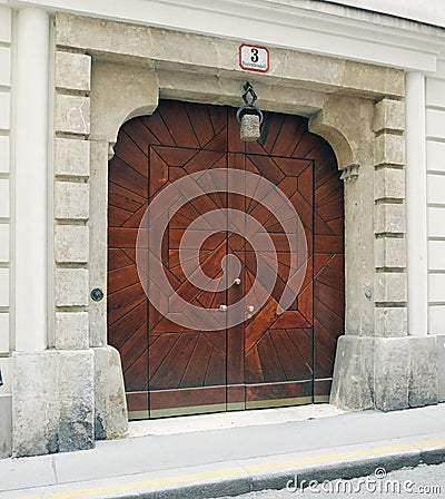 Vienna, Austria - 15 April 2018: ancient wooden doors. main entrance with family coat of arms. Editorial Stock Photo