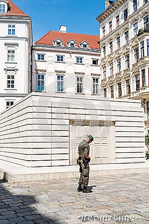 Soldier guarding Judenplatz Holocaust Memorial in historical cit Editorial Stock Photo