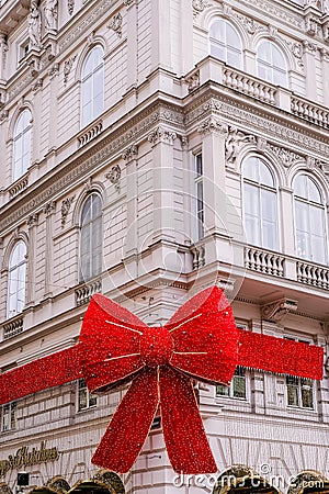 Building facade decorated with Christmas Red Bow on Popp and Kretschmer department store Editorial Stock Photo