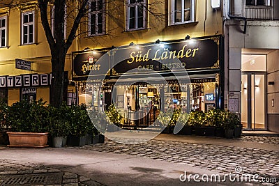 Christmas Street with Illuminated Cafe at Dusk Editorial Stock Photo