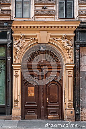 Vienna, Austria - Feb 7, 2020: Wooden gate with goddess embellishment on Josephstadt street in city center Editorial Stock Photo