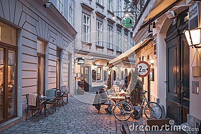 Vienna, Austria - July, 2020: Cafe at the street in the center of Vienna with old man drinking coffee Editorial Stock Photo