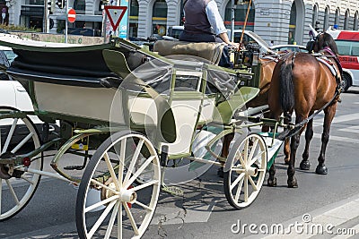 Vienna / Austria - 31 July 2019: Coach driving in the streets of vienna, Austria with the baroque carriage vehicle with horses for Editorial Stock Photo