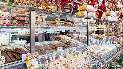 People buy Christmas baubles, toys and souvenirs at traditional Christmas market in front of Editorial Stock Photo