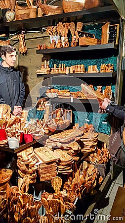 People buy Christmas baubles, toys and souvenirs at traditional Christmas market in front of Editorial Stock Photo