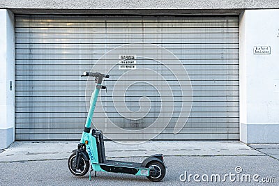 Vienna, Austria - 10 05 2022 - Willfully inconveniently parked e-scooter blocks a garage entrance despite sign Vienna, Lower Editorial Stock Photo