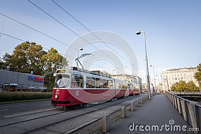 Vienna tram, also called strassenbahn, an old and traditional modern, passing by on the iconic ringstrasse in the city center Editorial Stock Photo