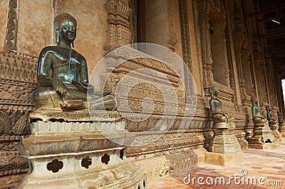 Buddha statues located at the outside wall of the Hor Phra Keo museum building in Vientiane, Laos. Editorial Stock Photo