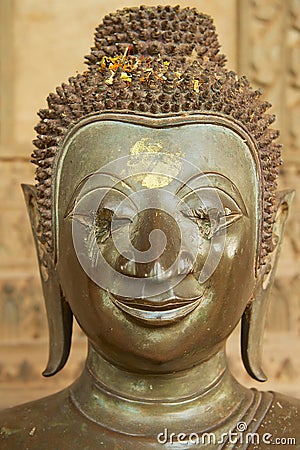 Head of the damaged old Buddha statue located at the outside wall of the Hor Phra Keo museum building in Vientiane, Laos. Editorial Stock Photo