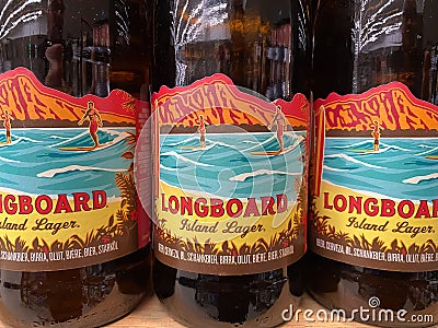 Closeup of bottels Kona hawaiian craft beer longboard in shelf of german supermarket Editorial Stock Photo