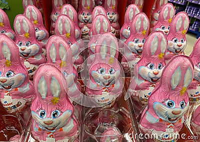 Closeup of many pink kinder chocolate easter bunnies in shelf of german supermarket Editorial Stock Photo