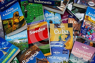 Travel around the world - View on pile of lonely planet travel guide books from different Editorial Stock Photo