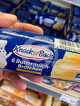 View on hand holding packet knack und back prebaked bread rolls in german supermarket Editorial Stock Photo